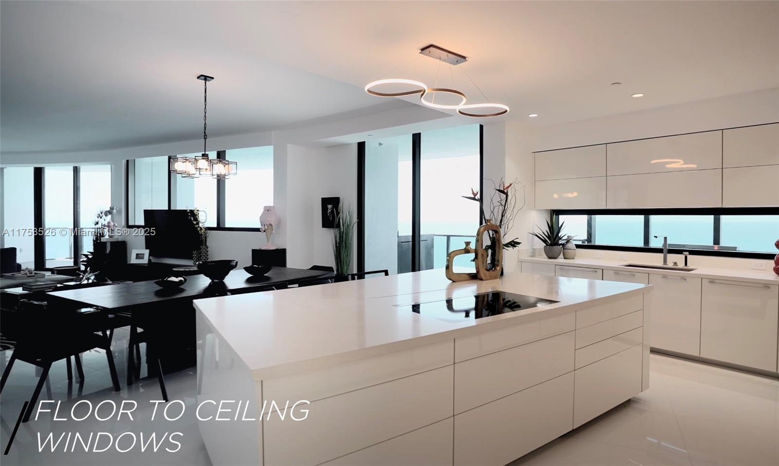 18555 Collins Avenue, Unit 3601 Sunny Isles Beach, FL 33160 - Photo 6 of 16 a kitchen with counter top space appliances and cabinets