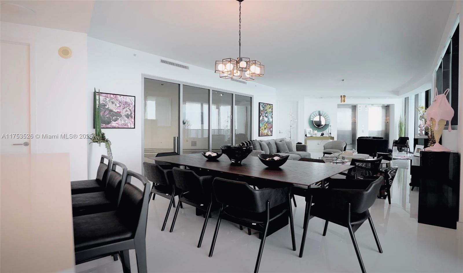 18555 Collins Avenue, Unit 3601 Sunny Isles Beach, FL 33160 - Photo 7 of 16 a view of a a dining room with furniture window and wooden floor