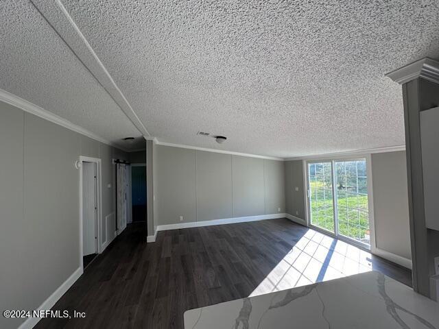 4987 Hemlock Road Macclenny, FL 32063 - Photo 12 of 17 an empty room with wooden floor and windows