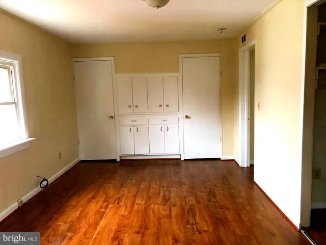 a view of an empty room and wooden floor