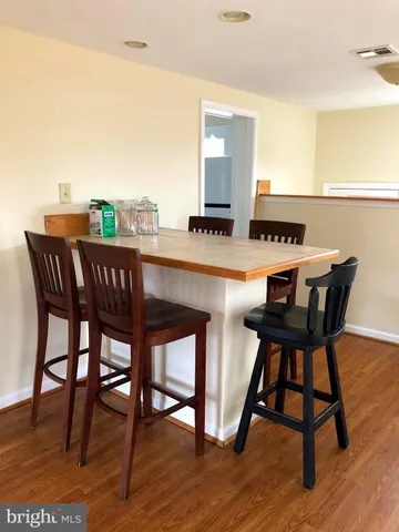 a dining room with a wooden table and chairs