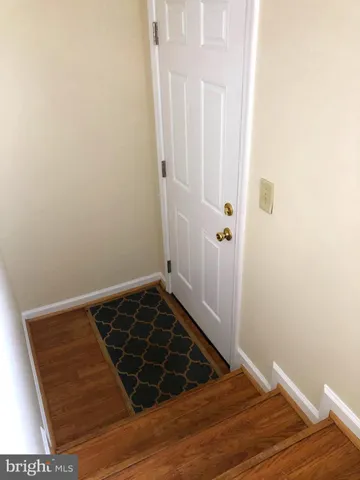 a view of a room with wooden floor