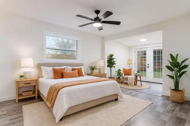 a bedroom with a large bed and a chandelier