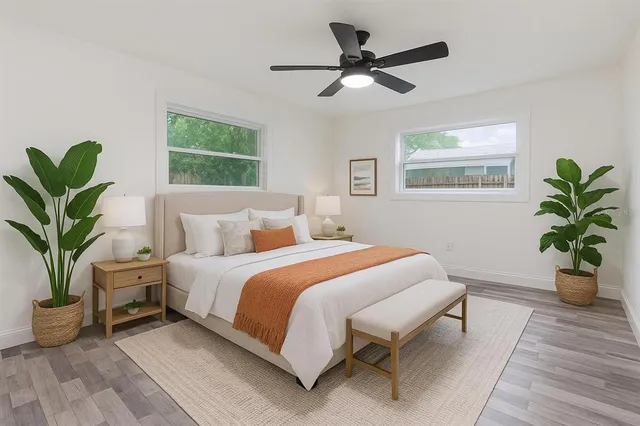 a bedroom with a large bed and a chandelier