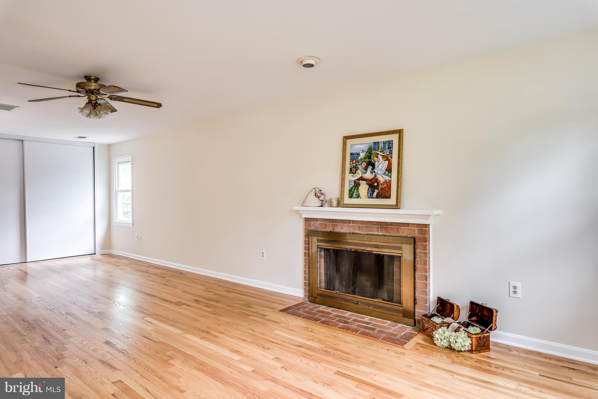 1709 Birch Road McLean, VA 22101 - Photo 18 of 30 a view of a livingroom with a fireplace a ceiling fan and wooden floor