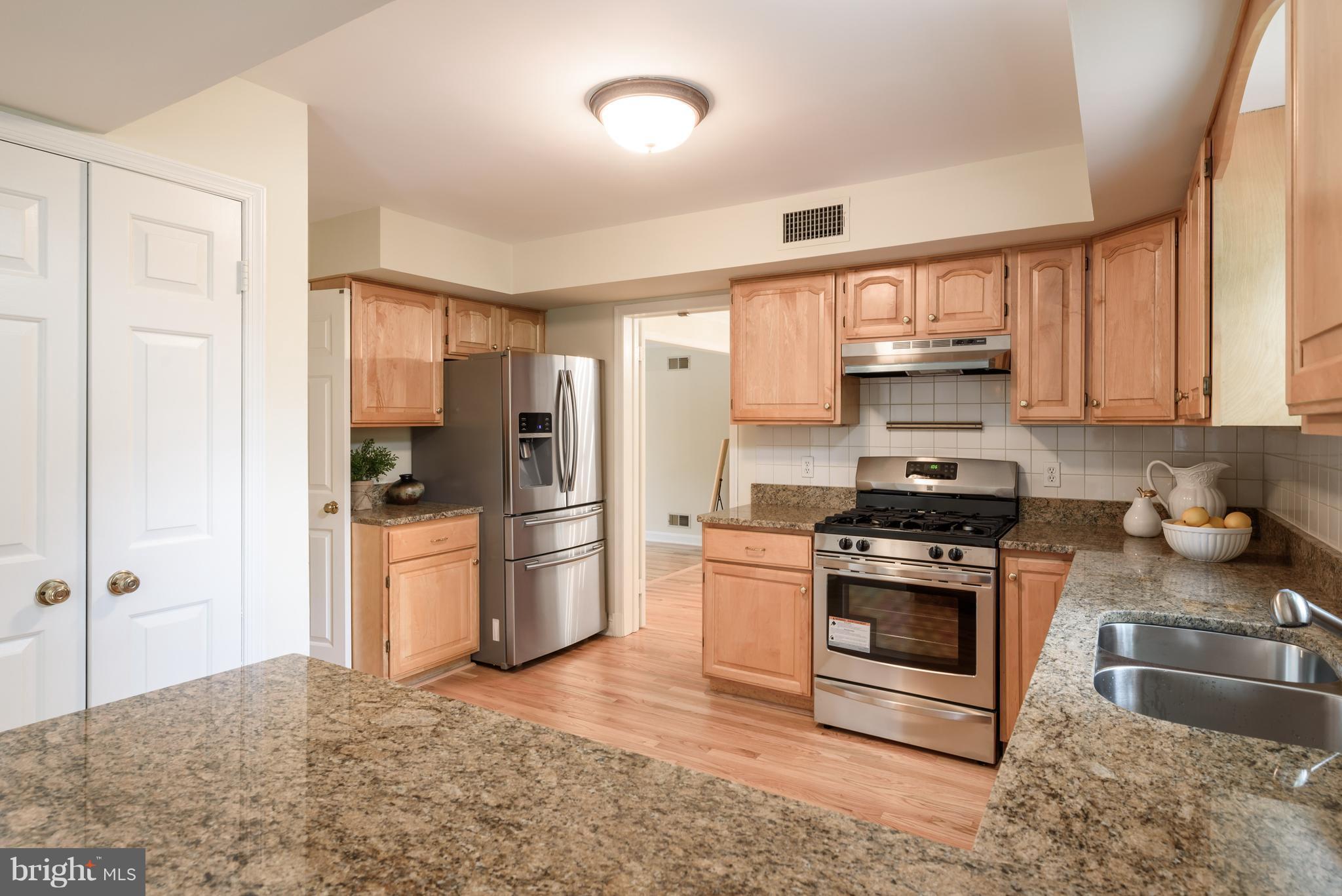 1709 Birch Road McLean, VA 22101 - Photo 19 of 30 a kitchen with stainless steel appliances granite countertop a refrigerator stove and sink