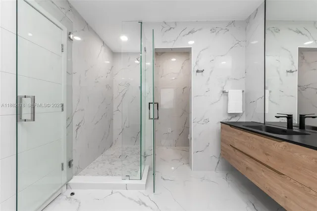 a bedroom with a bed and a view of kitchen