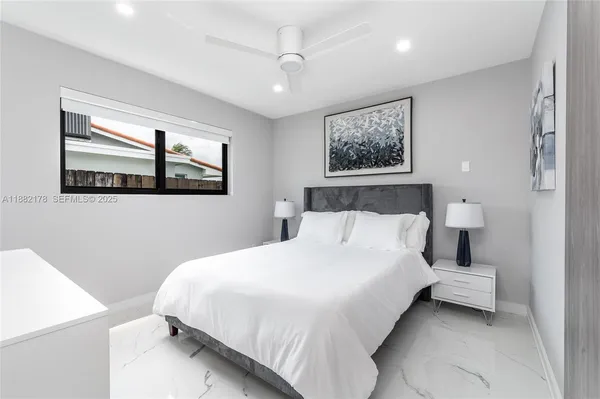 a bedroom with a bed and a view of bathroom