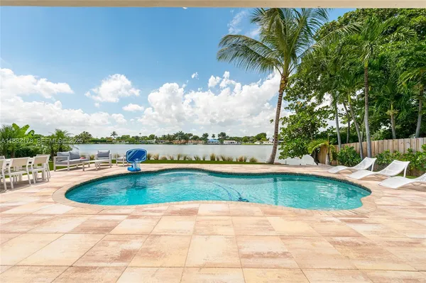 a house view with swimming pool and garden