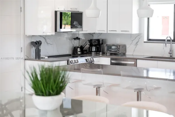 a kitchen with a sink a counter and cabinets