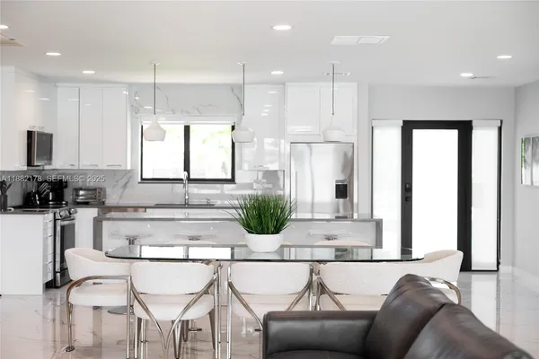 a kitchen with a refrigerator and white cabinets