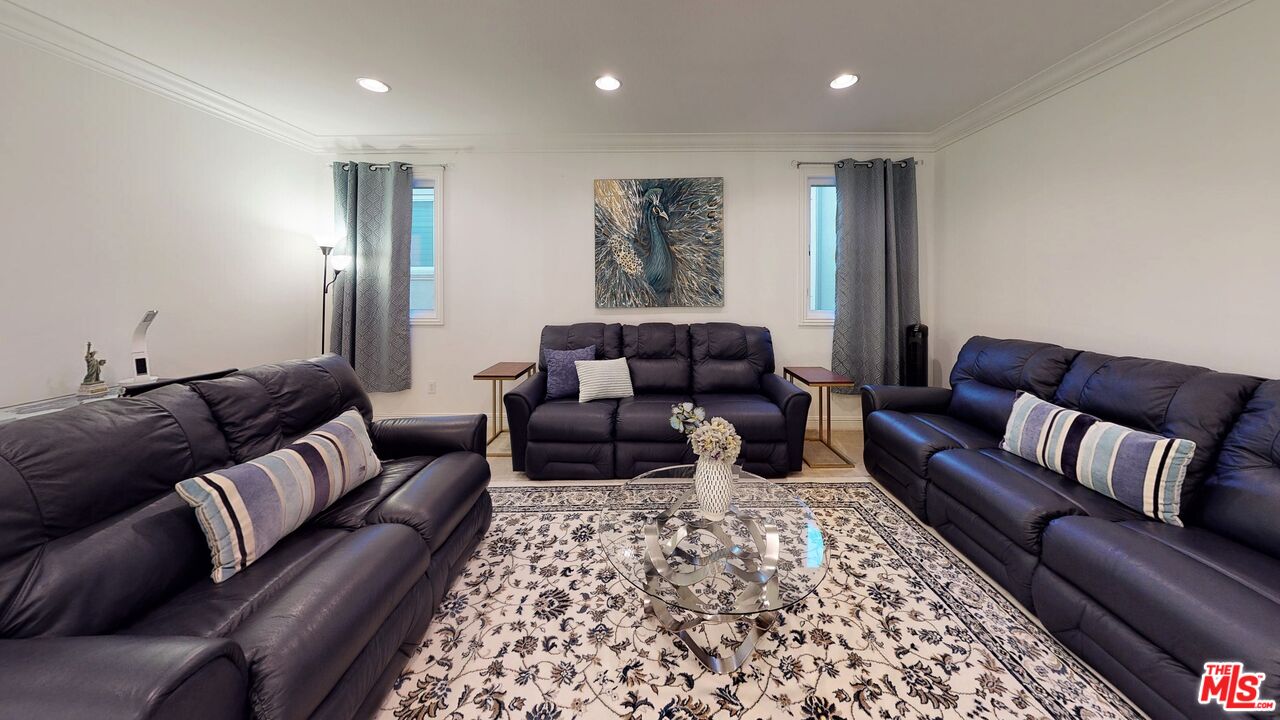11945 Ancona Way Porter Ranch, CA 91326 - Photo 40 of 50 a living room with furniture and a couch