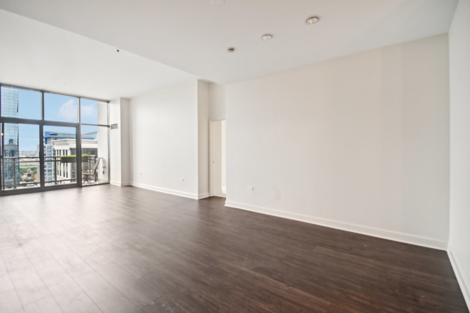 1335 South Prairie Avenue, Unit 2009 Chicago, IL 60605 - Photo 4 of 30 a view of an empty room with wooden floor and a window