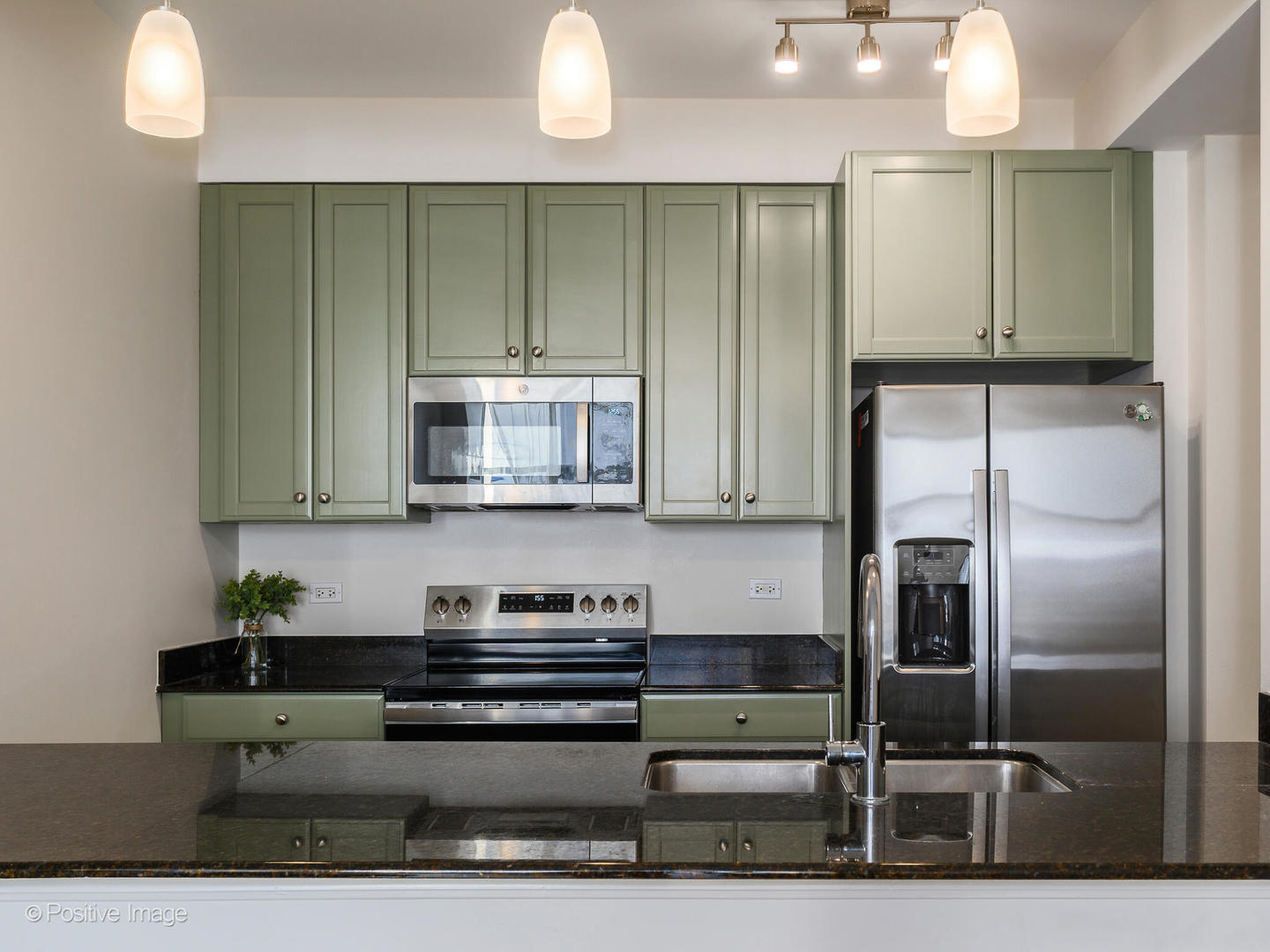 1335 South Prairie Avenue, Unit 2009 Chicago, IL 60605 - Photo 7 of 30 a kitchen with stainless steel appliances kitchen island granite countertop a refrigerator and a stove top oven