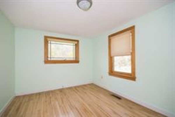 332 Williamsburg Road Conway, MA 01096 - Photo 3 of 10 an empty room with wooden floor and windows