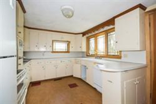 332 Williamsburg Road Conway, MA 01096 - Photo 8 of 10 a kitchen with granite countertop a sink and a stove with white countertops