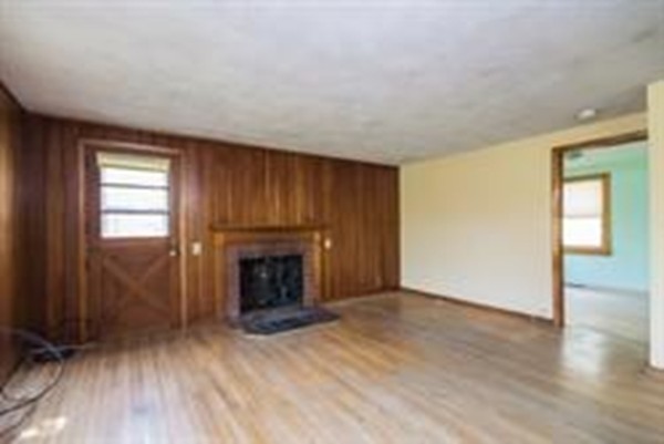 332 Williamsburg Road Conway, MA 01096 - Photo 10 of 10 an empty room with wooden floor fireplace and windows
