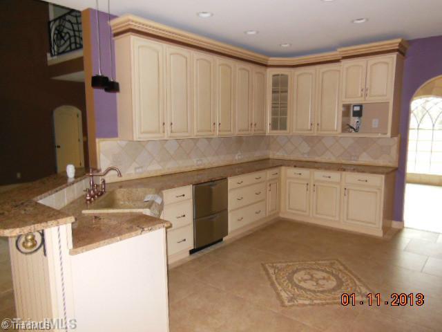 497 Griffith Road Advance, NC 27006 - Photo 5 of 16 Kitchen. Kitchen features custom cabinets and a granite sink
