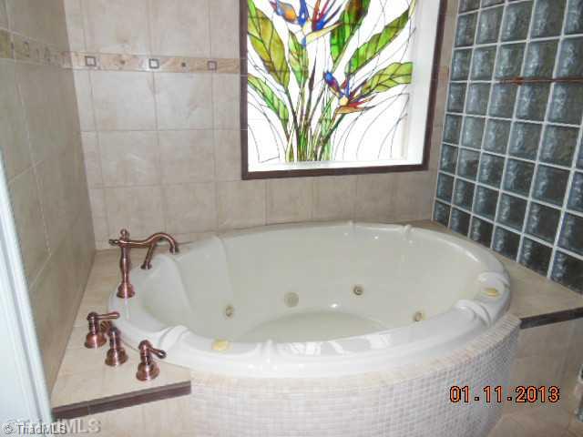 497 Griffith Road Advance, NC 27006 - Photo 9 of 16 Master Bath/Spa. Large jetted tub in Master Bath features a hand made stained glass window