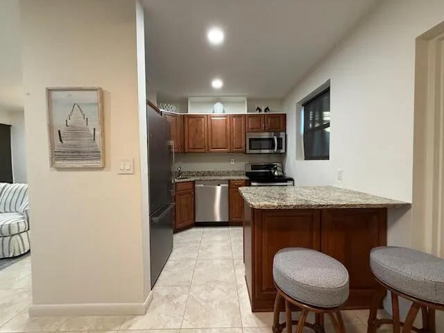 a kitchen with a sink cabinets and wooden floor