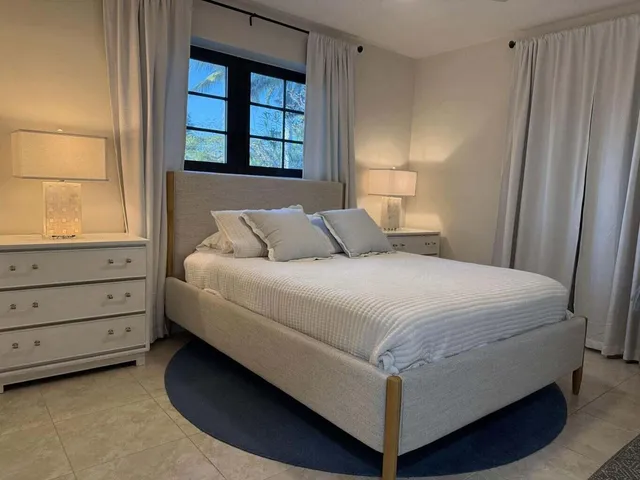 a bedroom with a bed and a window dresser