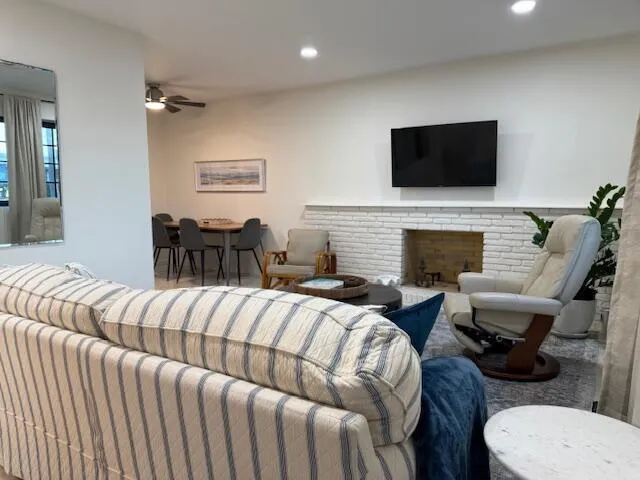 a living room with furniture fireplace and a flat screen tv