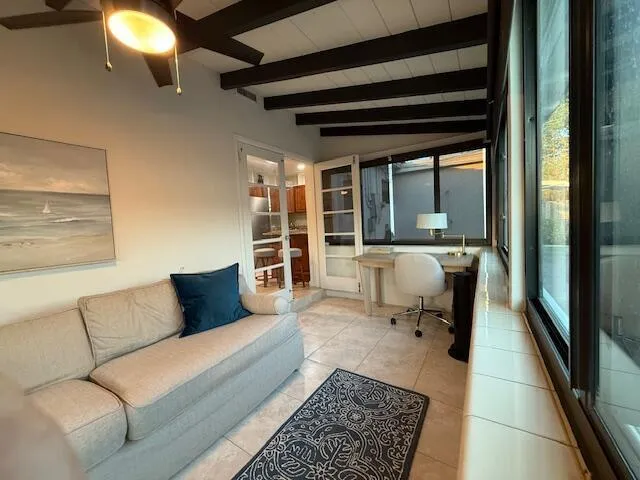 a living room with furniture and a floor to ceiling window