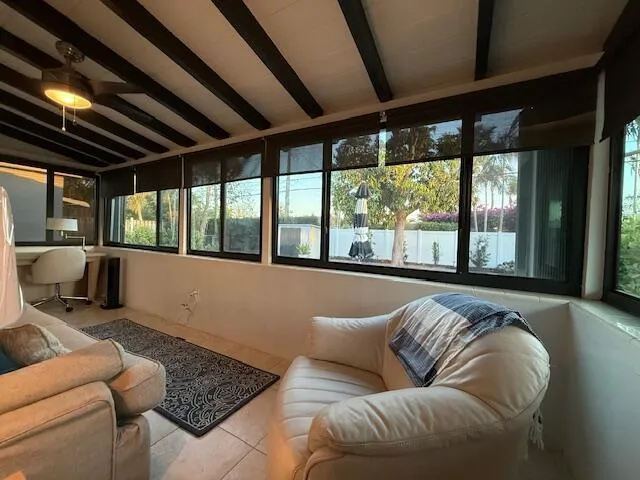 a living room with furniture and large windows