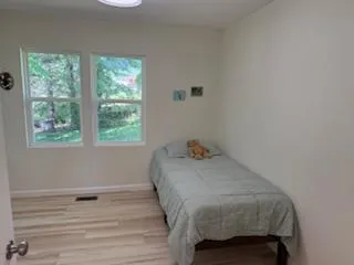 a bedroom with a bed and a window