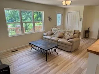 a living room with furniture a table and a window