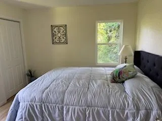 a bedroom with a bed and a window