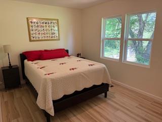 102 Ledford Chapel Road Hayesville, NC 28904 - Photo 8 of 30 a bed sitting in a bedroom next to a window