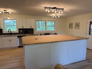 102 Ledford Chapel Road Hayesville, NC 28904 - Photo 10 of 30 a kitchen with a sink window and cabinets