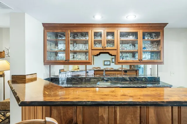 a front view of a house with a yard and tree s