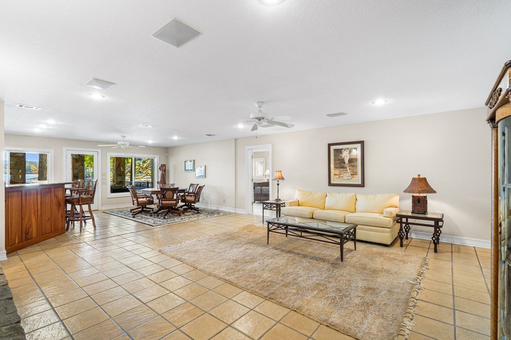 1370 Heathers Cove Circle Hiawassee, GA 30546 - Photo 39 of 99 a living room with furniture and a dining table with wooden floor