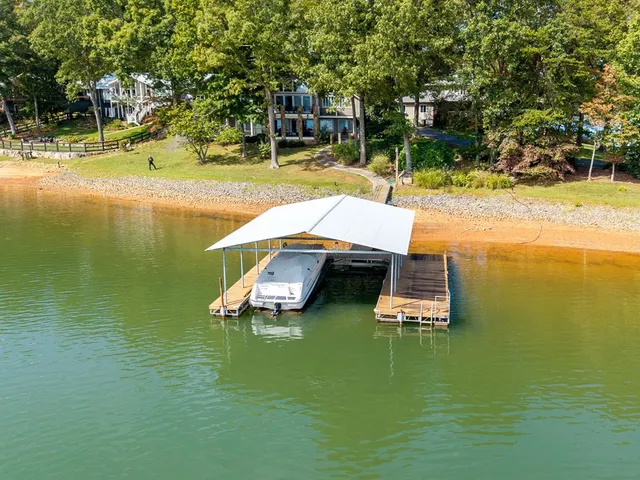 a living room with furniture large windows a rug and a floor to ceiling window