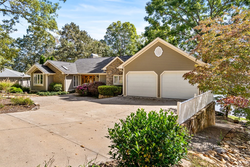 1370 Heathers Cove Circle Hiawassee, GA 30546 - Photo 79 of 99 a front view of a house with a yard and garage
