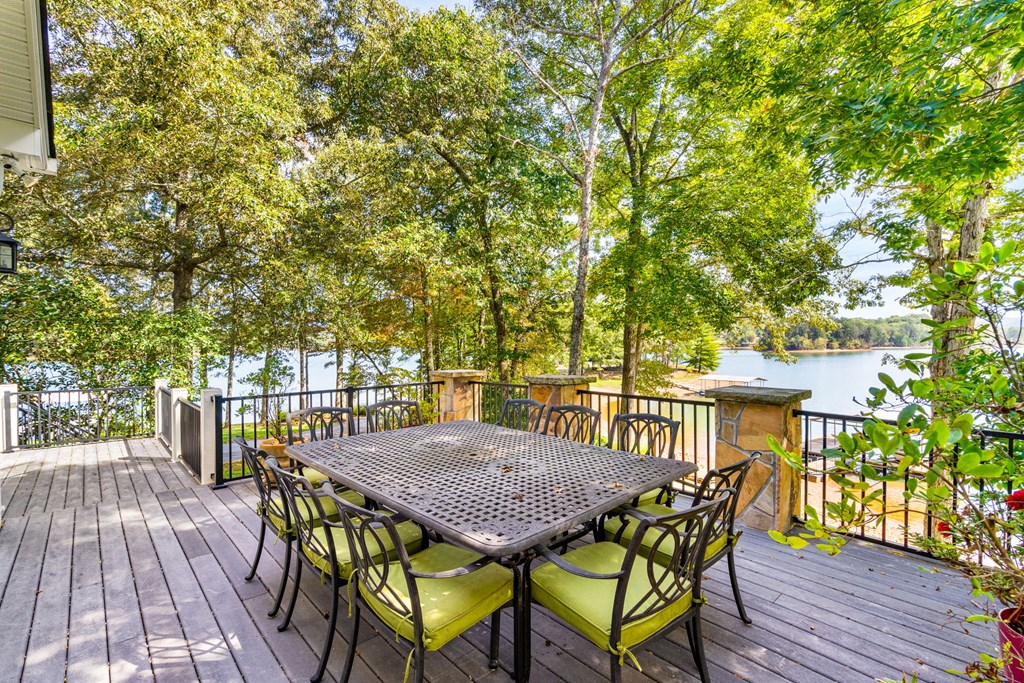 1370 Heathers Cove Circle Hiawassee, GA 30546 - Photo 90 of 99 a view of a patio with table and chairs with wooden floor and fence