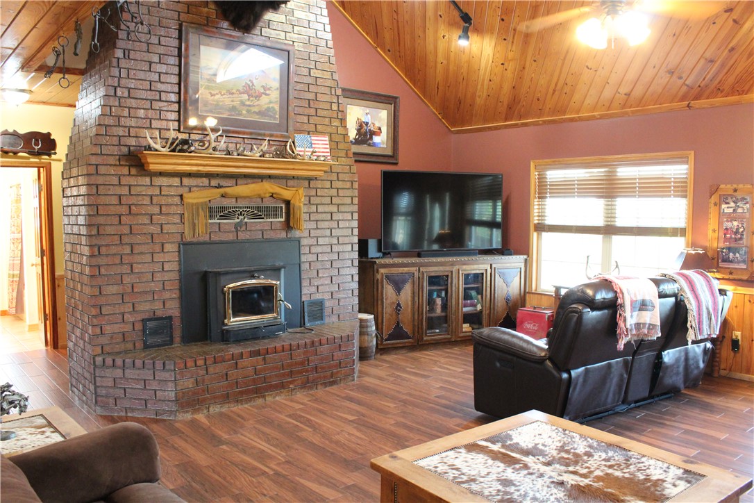 2210 Weiterer Road Scranton, AR 72863 - Photo 22 of 49 Brick fireplace with a wood-burning insert and a prominent mantel