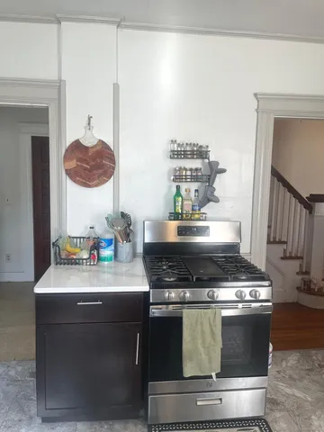a stove top oven sitting inside of a kitchen