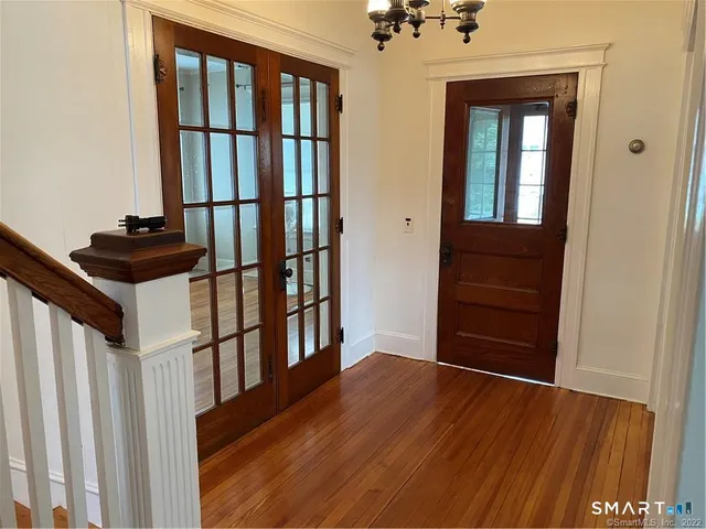 a view of front door with wooden floor