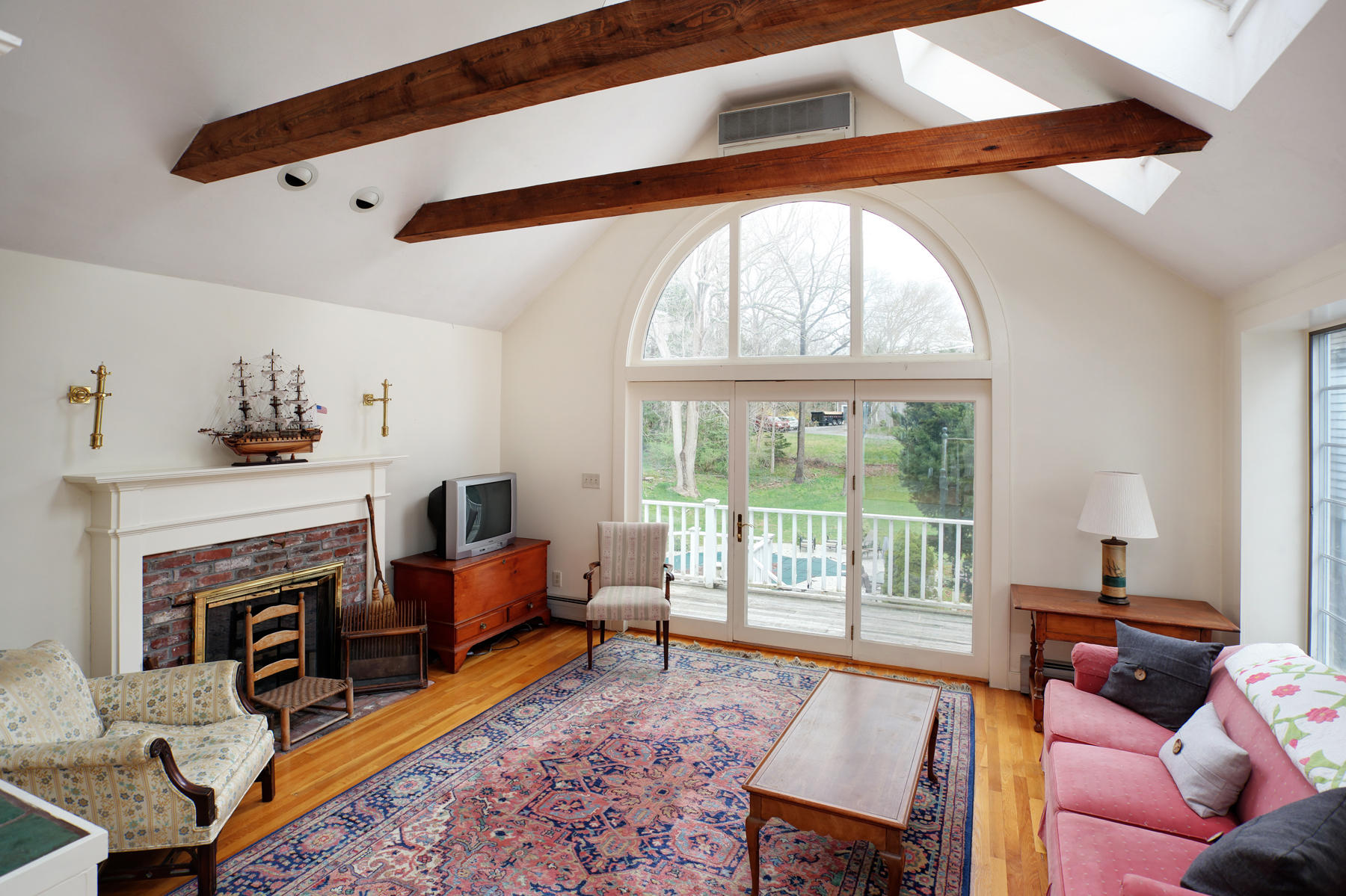 463 Main Street Centerville, MA 02632 - Photo 18 of 36 a living room with furniture and a fireplace