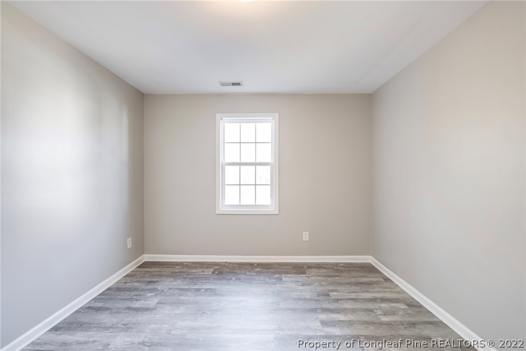 3104 Guiding Light Road Raleigh, NC 27610 - Photo 25 of 36 wooden floor in an empty room with a window