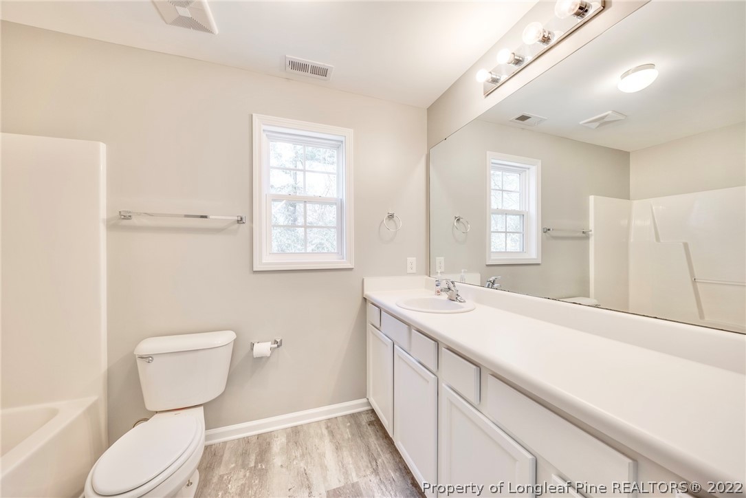 3104 Guiding Light Road Raleigh, NC 27610 - Photo 30 of 36 a bathroom with a toilet sink and mirror