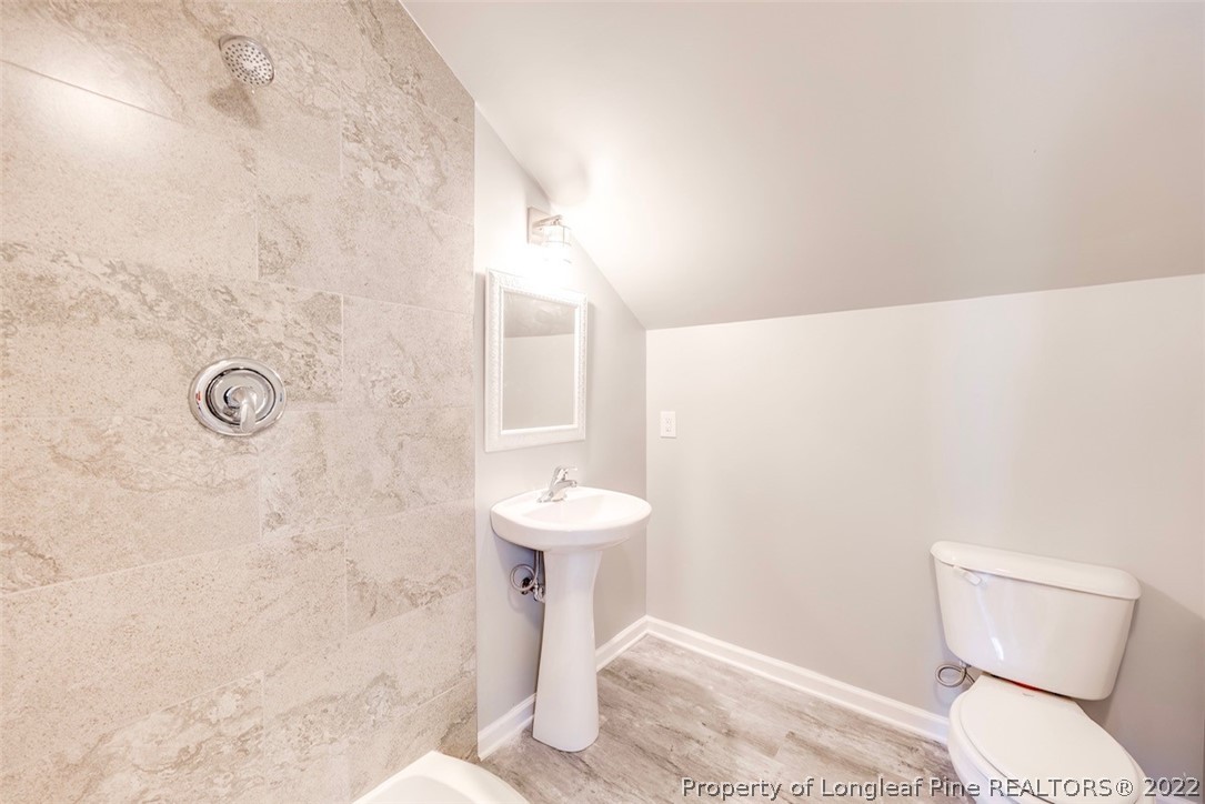 3104 Guiding Light Road Raleigh, NC 27610 - Photo 33 of 36 a bathroom with a toilet sink and shower
