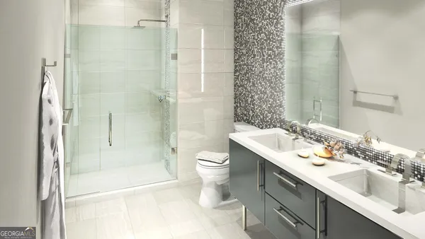 a bathroom with a double vanity sink toilet and shower