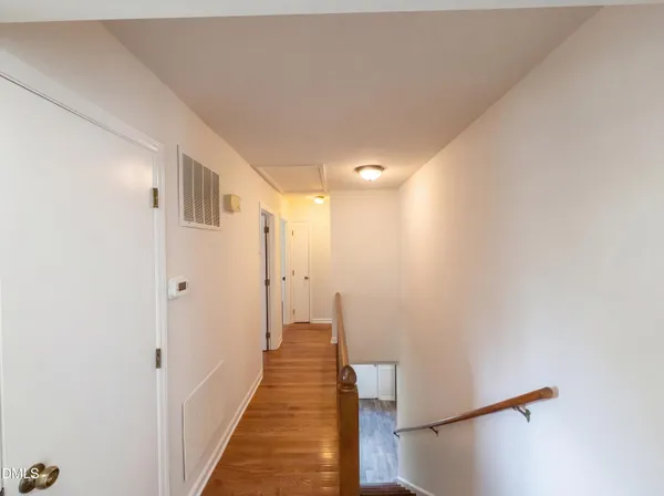 a view of a hallway with white walls