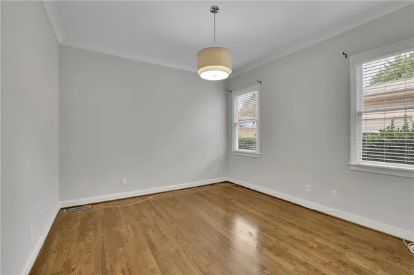 a view of a room with wooden floor and fan