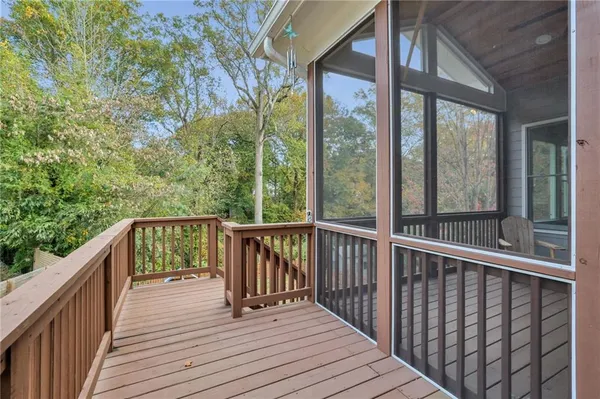 a view of balcony with wooden floor and fence
