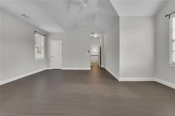 an empty room with a empty space and windows